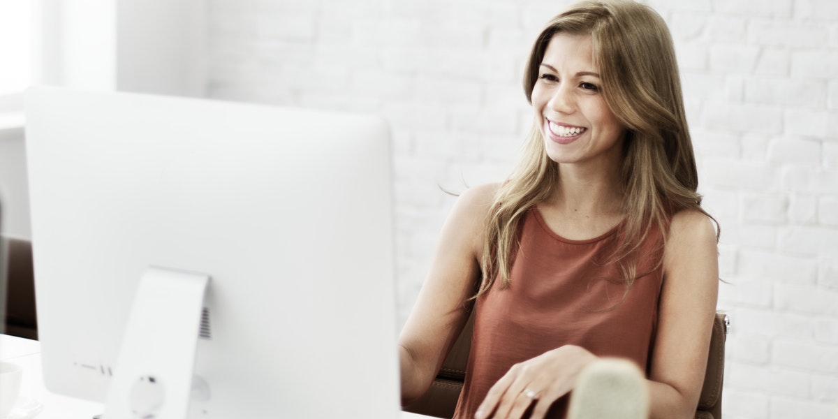 woman smiling at her desk